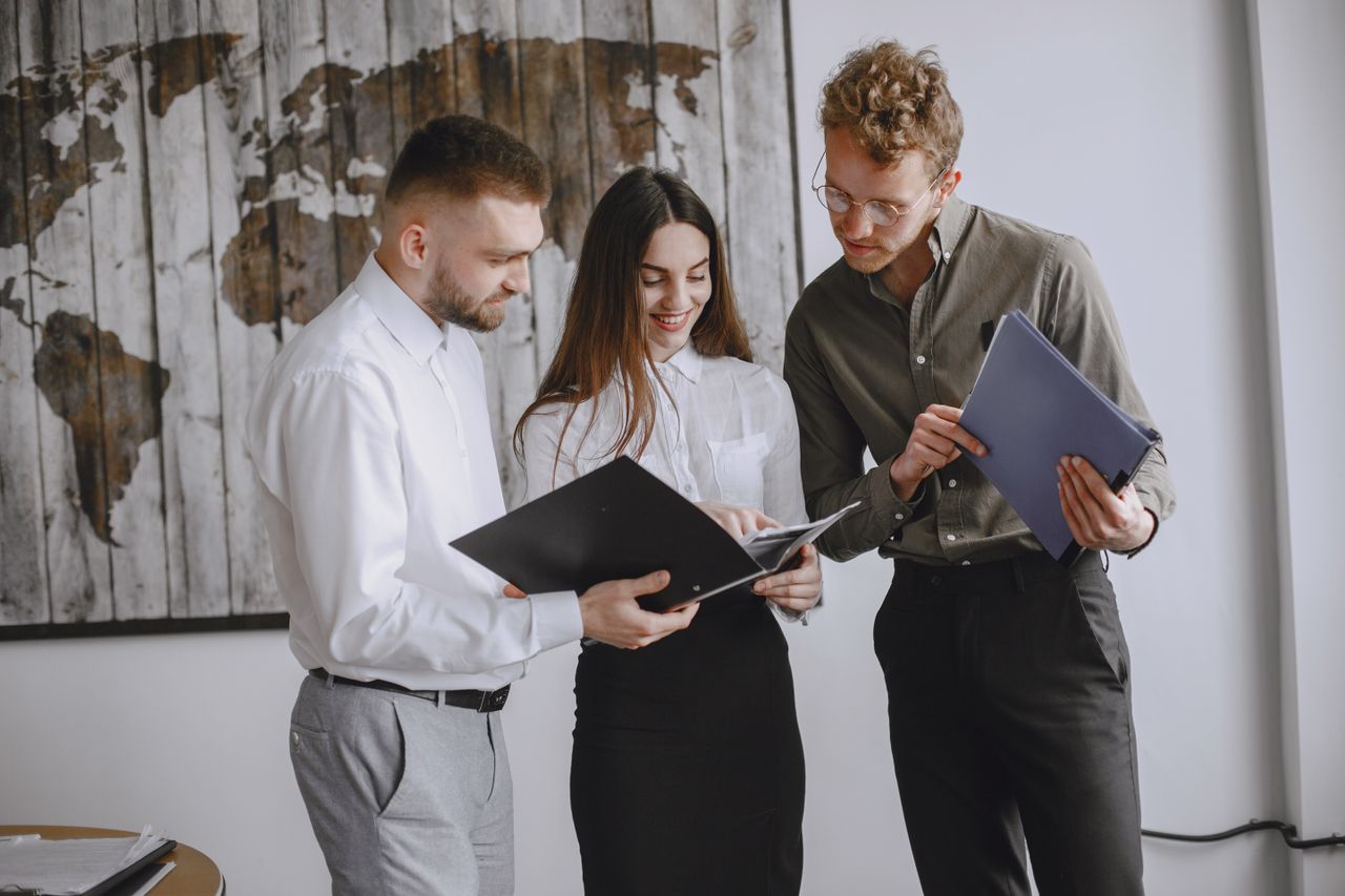 Services Professional team engaged in a meeting, reviewing documents together in a modern office space.
